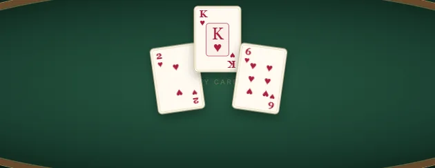 Spades cards from a naturally played trick: the two, king and six of hearts on the green table.